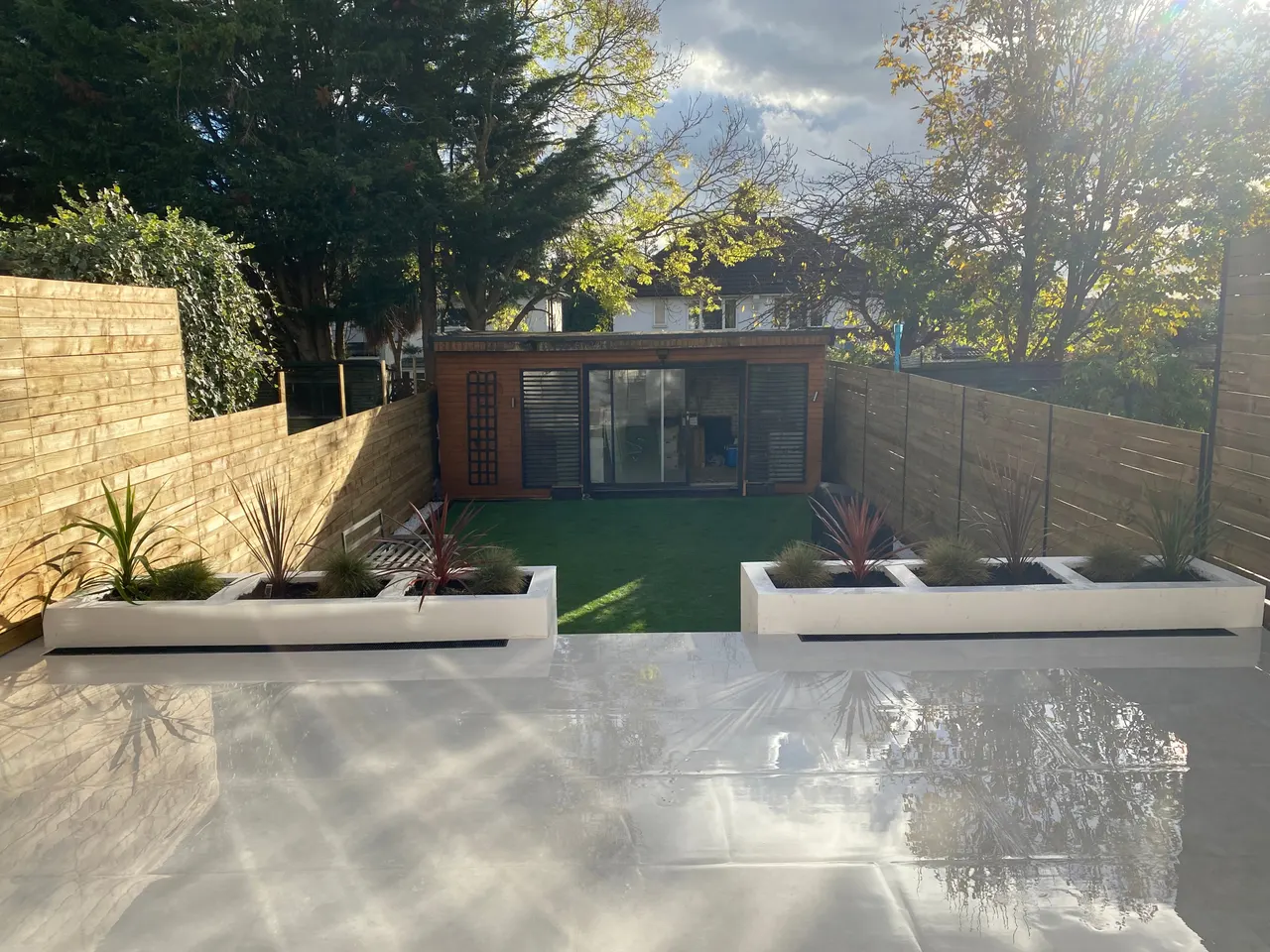 Finished garden with porcelain patio and rendered planters